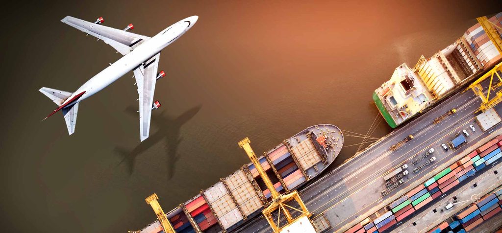 An aerial view of a cargo plane flying over a port with container ships and cranes, representing the different 1688 shipping methods to US.