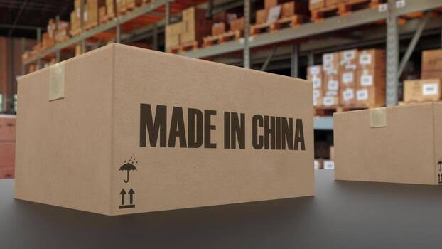 A cardboard box labeled "MADE IN CHINA" with shipping symbols on a table, representing the logistics of China warehouses that ship to the USA.